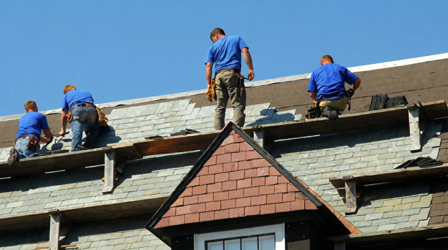 Roof replacement in progress with a team of professional contractors installing new shingles on a residential home in Bakersfield, CA