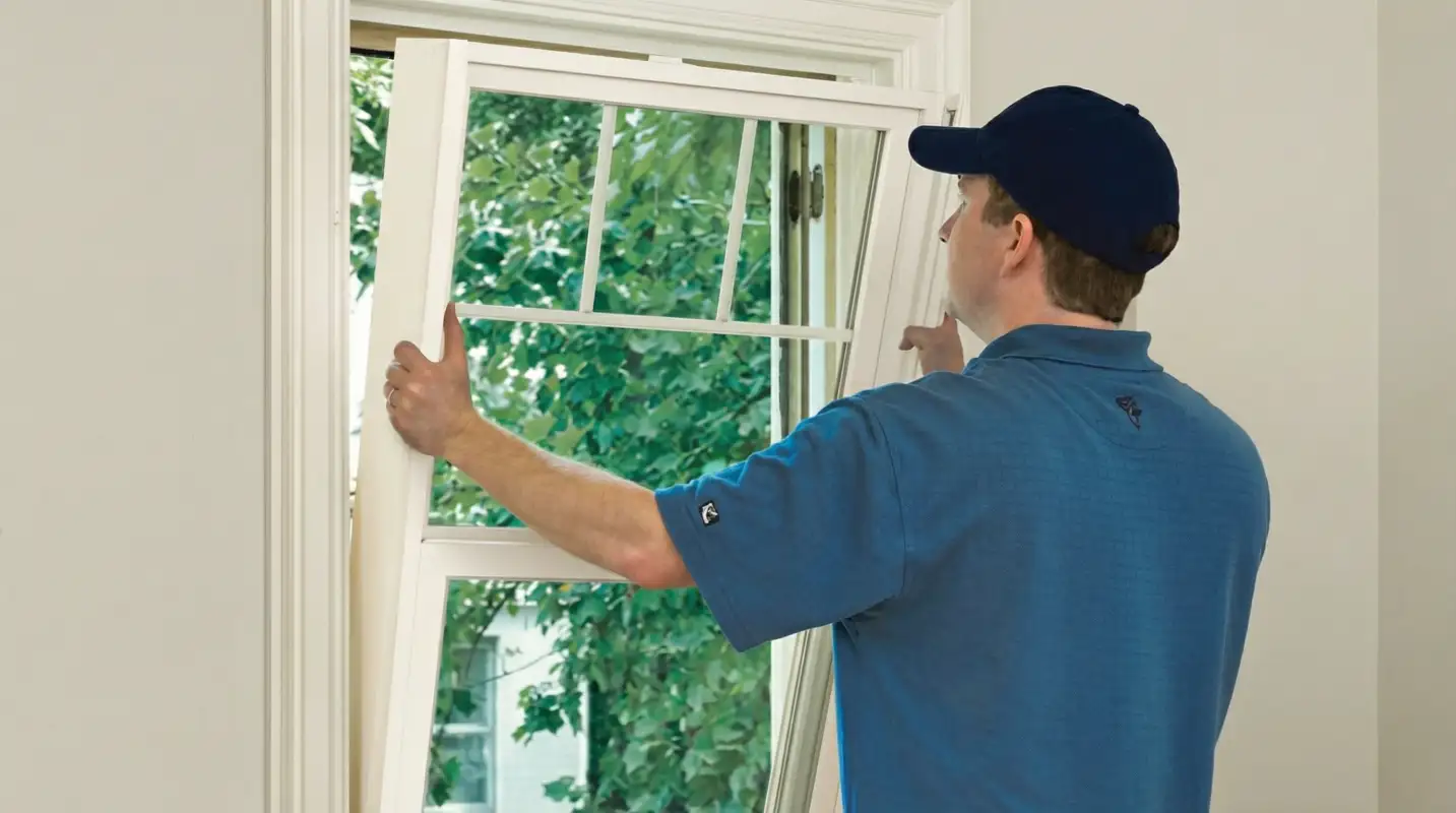 Professional contractors performing a residential window insulation and replacement service in Bakersfield, CA